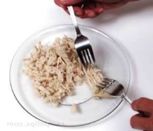 shredding chicken with a fork
